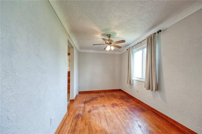 Dining room with coved ceiling and hardwood floors.