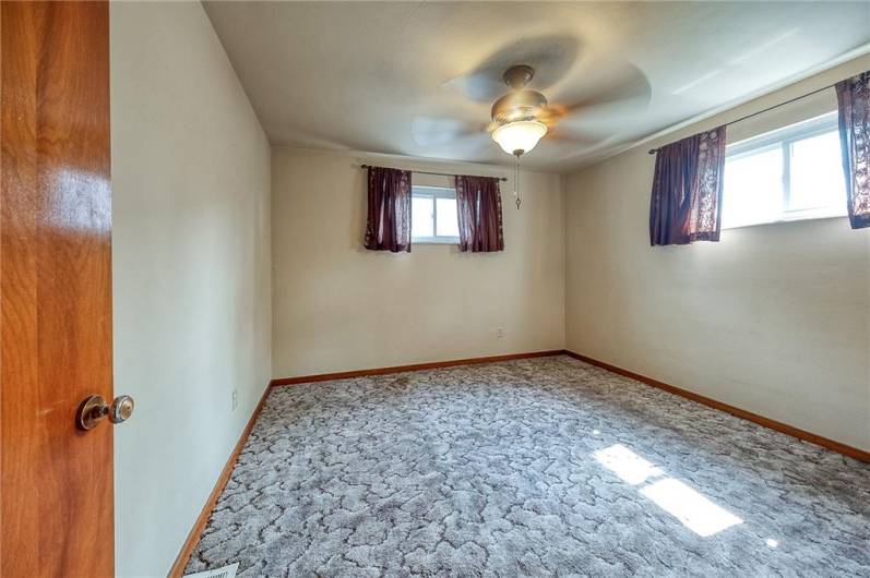Main level bedroom with large closet and hardwood floors.