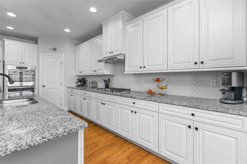 Plenty of recessed lighting...pantry...easy-clean tile back-splash!