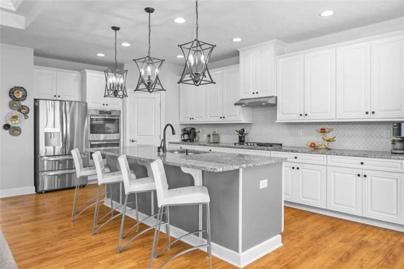 The center island breakfast bar design will be perfect for quick meals, after school snacks, baking or buffet service, or a glass of wine and a chat with the cook!