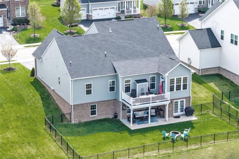 The deck overlooks the fenced rear yard...