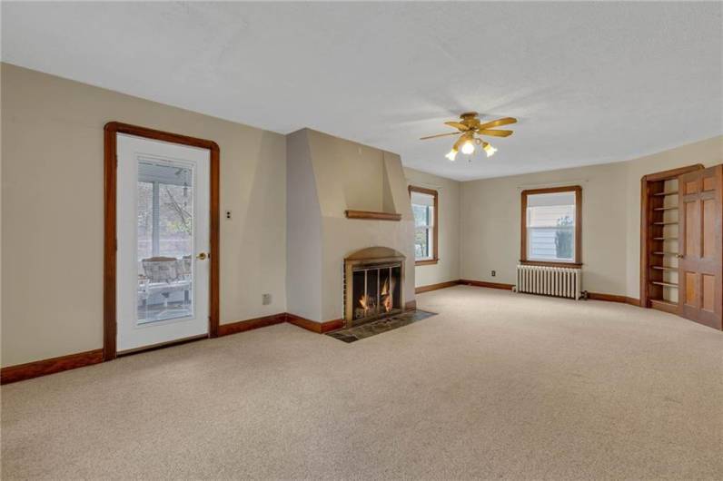 Living Room with Built in And Opens to Sunroom