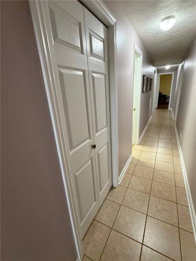 Main hallway to the bedrooms, baths and laundry is wide enough for a walker.