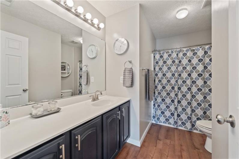 The updated shared bath has a fun blue vanity