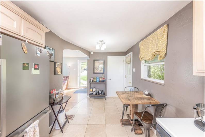 The kitchen area flows directly into the living room.  The door to the right leads to the covered side porch.