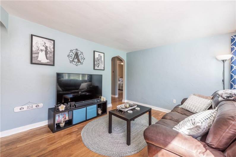 Bright living room with hard wood floors.