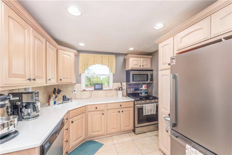 Stainless steel appliances and beautiful wood cabinetry.
