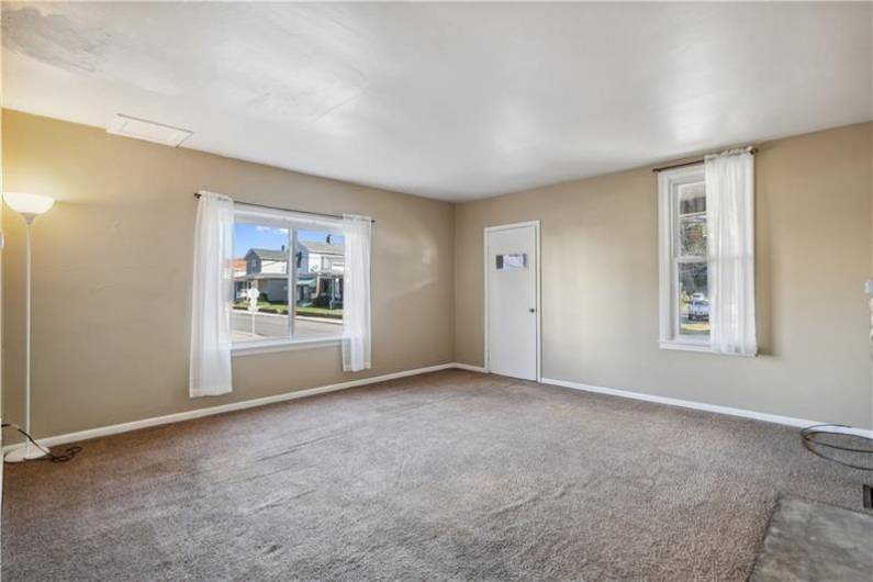 The 2nd Unit (700) is a mirror image. Spacious living room with neutral carpet.