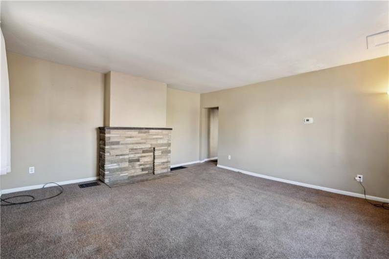 View of the decorative stone fireplace.