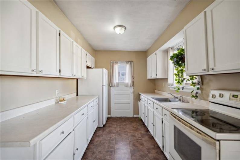 Great size kitchen with modern white cabinetry.