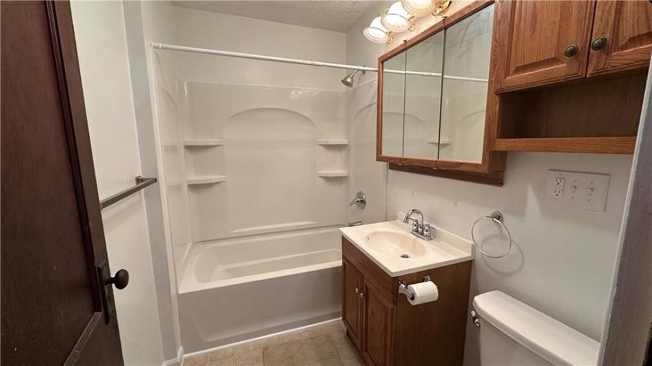 Full bathroom on main floor.  Newer tub and cabinets.  New fixtures.  Exhaust fan and ceramic floor.