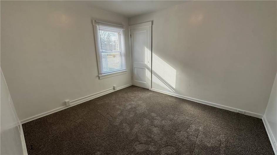 Primary bedroom.  Closet to right out of sight.  Closet ahead is walk up stairs to floored attic for storage.