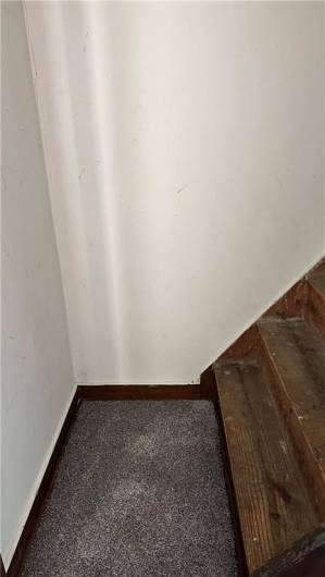 Closet with walk up stairs to attic.