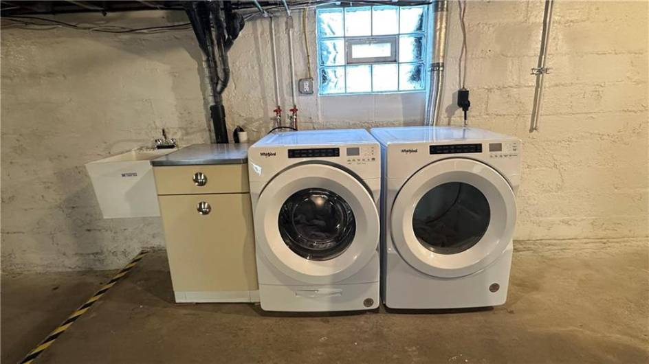 New washer, dryer and single laundry tub.