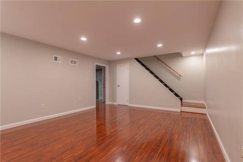 A view of the family room looking towards the laundry room and garage entrance.