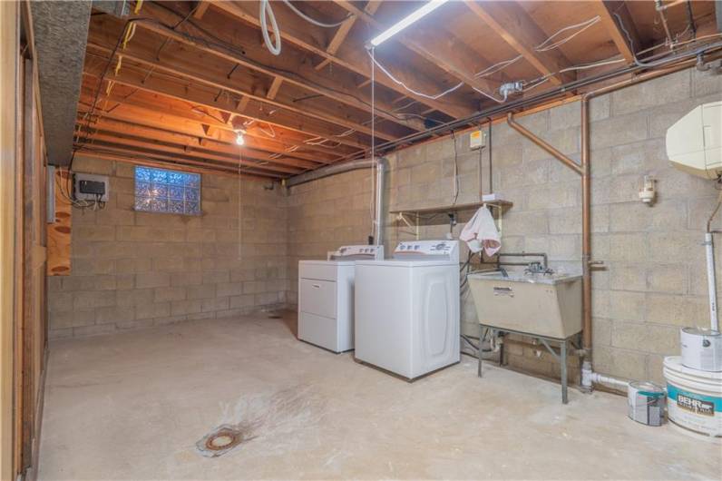 The huge unfinished part of the basement is completely dry and features a laundry area, tons of storage closets across from the laundry and space for a workout area.