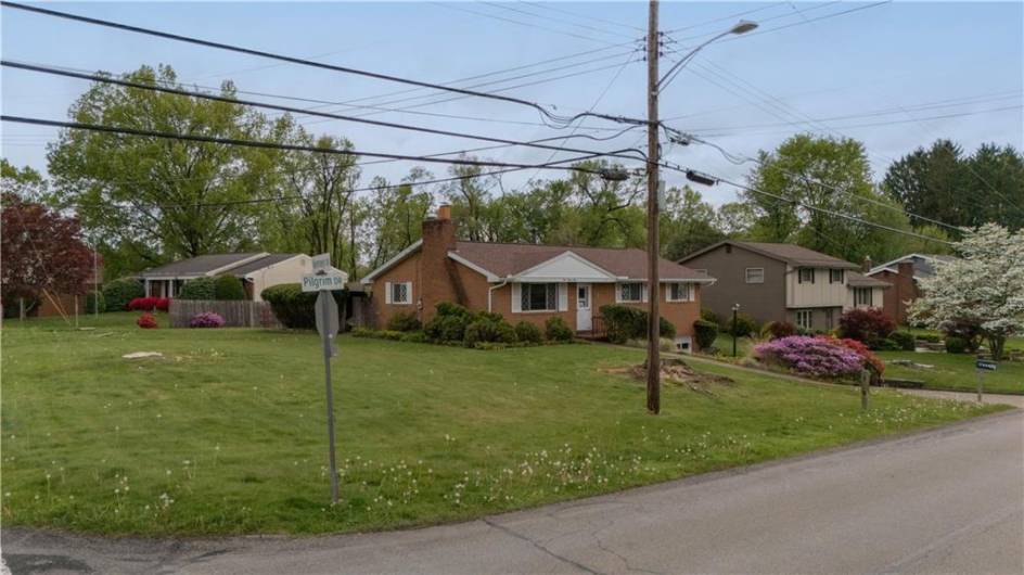 121 Pilgrim Drive sits on a very large corner lot at the intersection of pilgrim Drive and Kenney drive.  The bus stop is practically accross the street.
