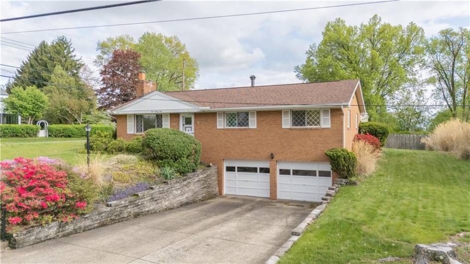 121 Pilgrim drive includes a large concrete driveway to the two car integral garage.