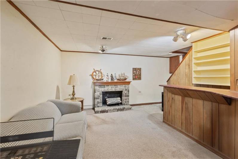 The finished game room has a bar & fireplace...