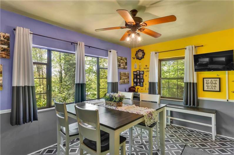 The formal dining room is bathed in light from the oversized picture window...