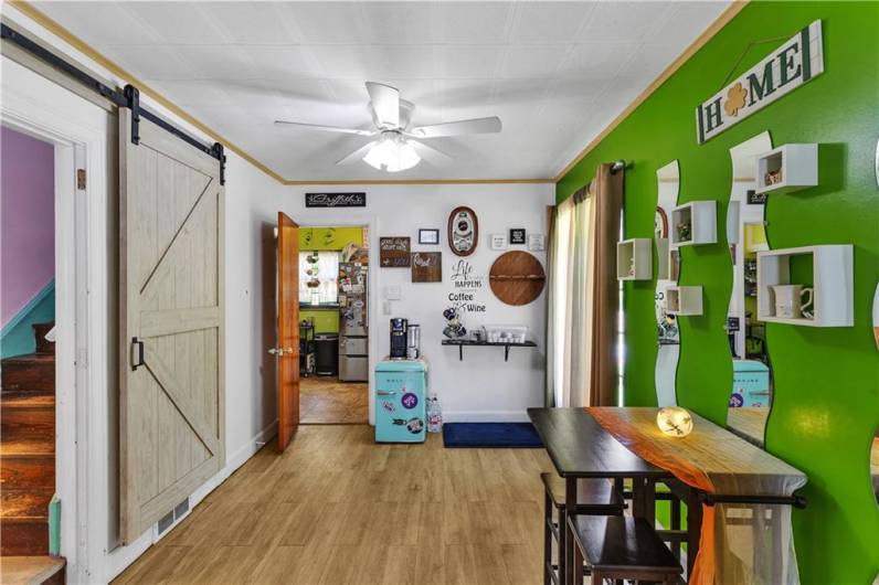 The barn door creates a nice separation between this den area & the stairwell...