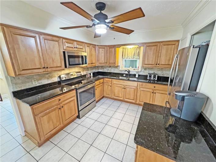 Updated kitchen with birch cabinets and granite countertops.