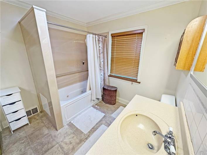 Main bath on the first floor has a jet tub with newer tub surround.