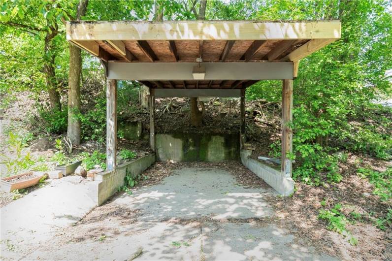 Covered parking in the rear of the property, off the alley. One car fits in the carport, and there's room for another parallel to the alley