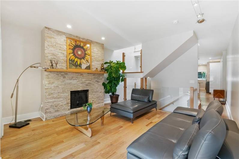 Clean, contemporary style defines this gracious, spacious living room. Daylight streams in via the large windows in the front, as well as an oversized skylight over the stairwell.