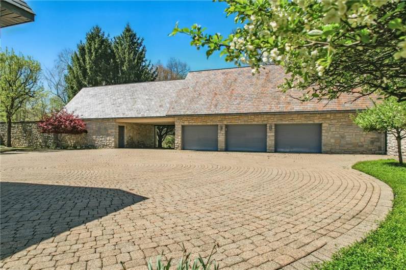 5 car garage.  Above the left wing of garage is a 1 bedroom, 1 bath apartment with fully separate living quarters.  Above the right wing is a 2nd 1 bedroom, 1 bathroom apartment accessible via garage & main home foyer.