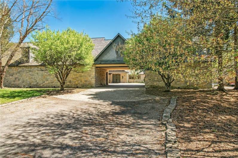 Arrive in style via the impressive porte-cochère, providing sheltered access to both the estate's central courtyard and the convenience of a five-car garage. This elegant architectural feature underscores the thoughtful design of 1700 Forker Blvd.