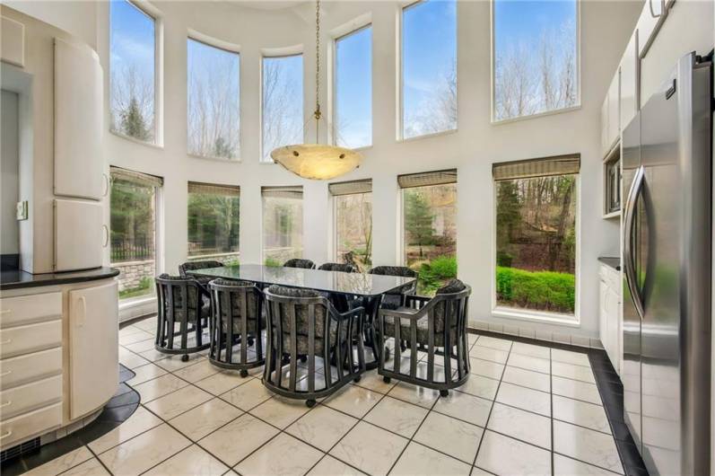 Bask in natural light and savor every meal in this architecturally striking dining space, seamlessly integrated with a gourmet kitchen.