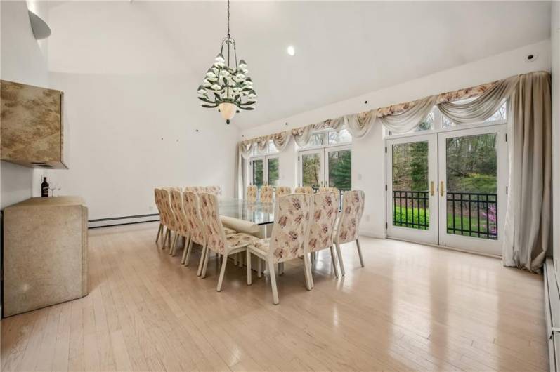 Host memorable gatherings in the elegant dining room, featuring abundant natural light, views of the surrounding landscape, and ample seating for sophisticated entertaining.