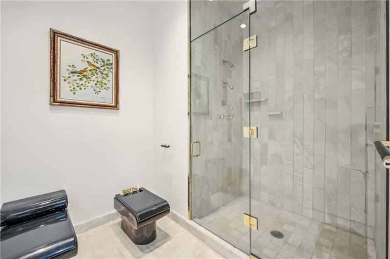 1 of 2 Primary bathrooms on the main floor suite offering 2 full bathrooms including bidet & tiled step in showers, soaking tub, and separate individual room closets