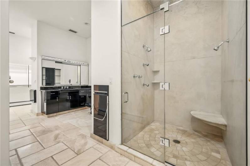 Experience ultimate comfort and style with two separate full bathrooms, one featuring the distinctive touch of a dedicated pants press