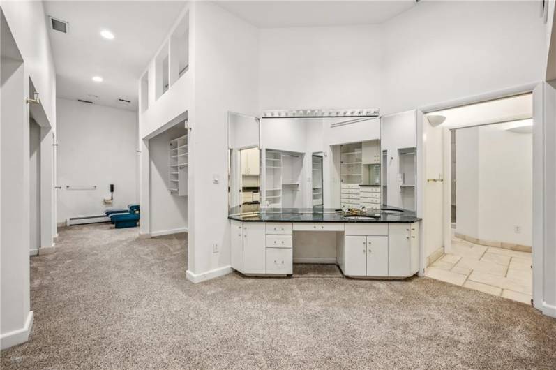 Indulge in this spa-like bathroom, complete with a dedicated get-ready area and an expansive closet for ultimate organization and style