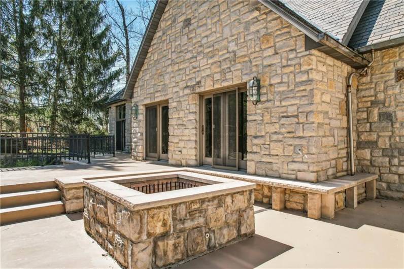 Designed for both beauty and function, this outdoor space features a stunning stone fire pit, creating a focal point for sophisticated gatherings.