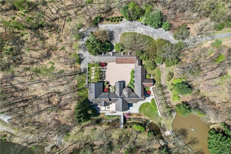 The heart of this estate unfolds into an expansive courtyard, a private oasis that seamlessly connects the main house to an impressive five-car garage and two beautifully appointed one-bedroom, one-bathroom bonus apartments, perfect for guests, extended family, or staff.