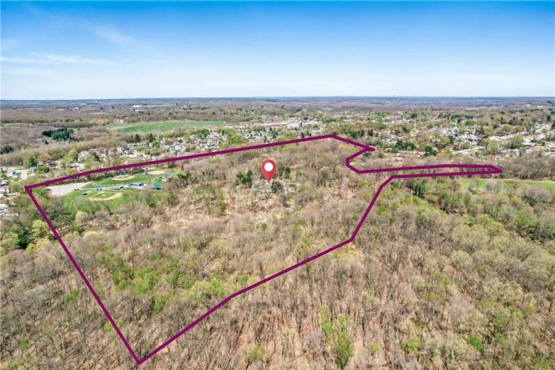 Soaring above the prestigious grounds of 1700 Forker Blvd, this extraordinary aerial perspective unveils a sprawling 37+ acre sanctuary of wooded tranquility.