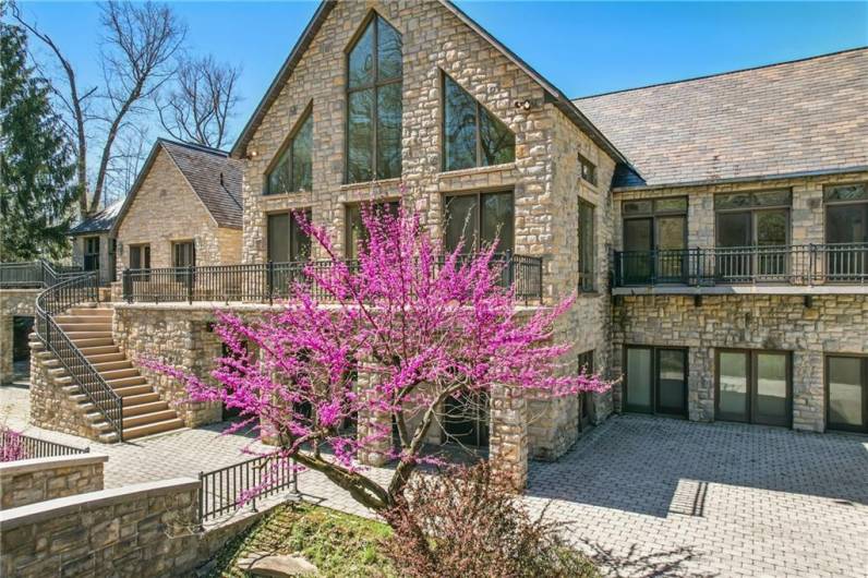 Impressive scale and presence. This magnificent home features a striking stone facade, expansive windows, and a design that perfectly complements its expansive grounds.