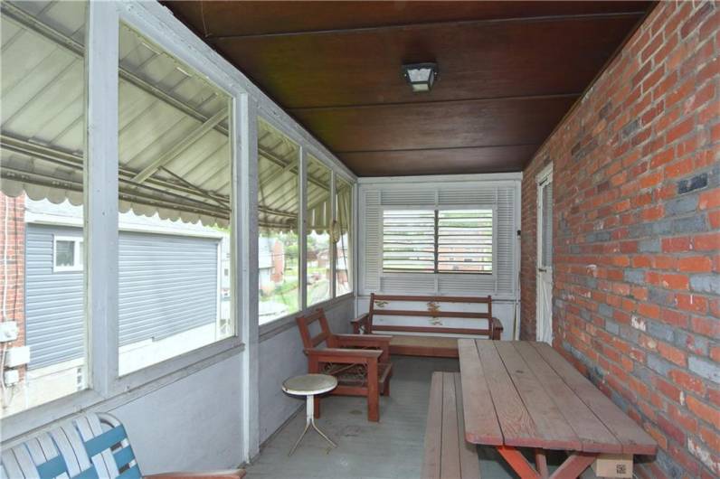 Side porch to enjoy summertime weather and the fun of eating outdoors. Has separate front entrance