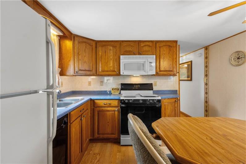 Eat in kitchen with custom cabinets.