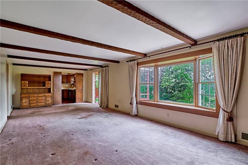 Reverse of the family room showing the kitchen in the background and a great view of the bay window overlooking the brick patio and yard.
