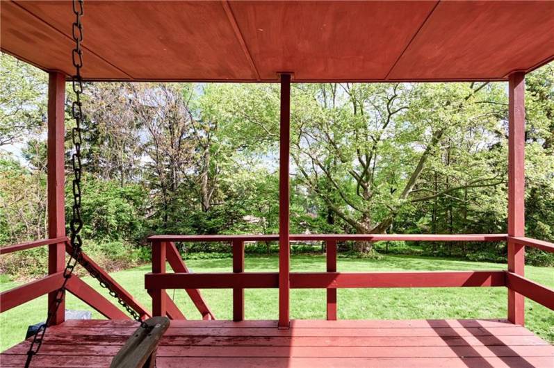 View from the swing on the covered deck. What a gorgeous view of the property! Note that gorgeous sycamore tree!