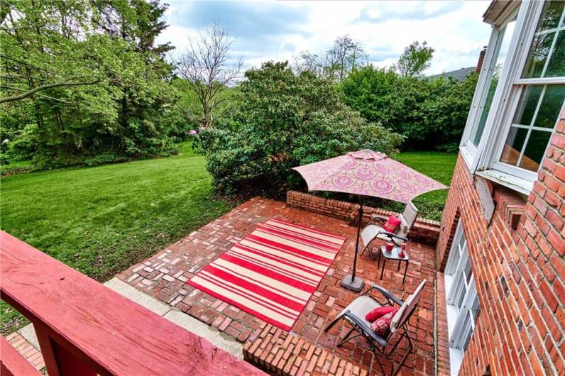 The brick patio from the vantage point of the deck.