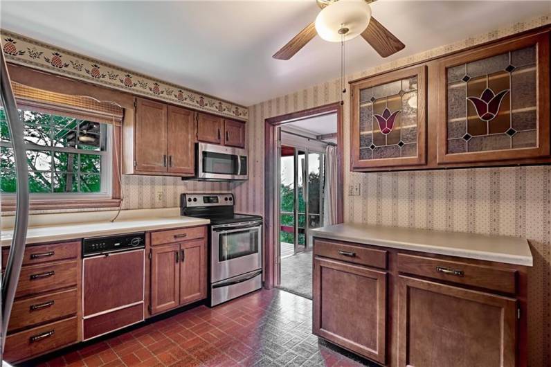 Another view of the kitchen. A lighted ceiling fan is a great feature. Note the proximity to the deck for entertaining.
