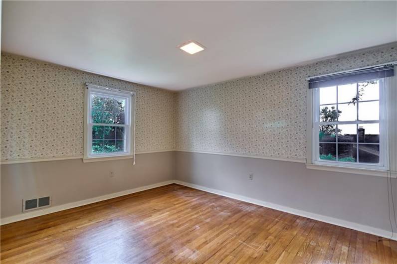 The third Bedroom has 2 large windows, a generous closet, overhead lighting, and hardwood floor.