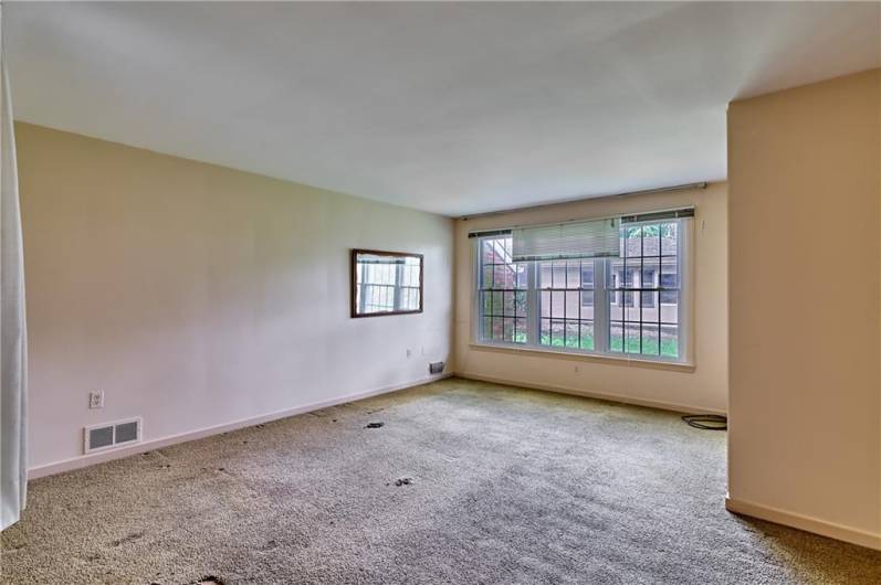 Main floor master bedroom. This room at 17 x 14 is easily used as a bedroom, but could also be a terrific hobby, exercise room, or playroom. The carpet has been removed since the photos were taken to present the hardwood underneath.