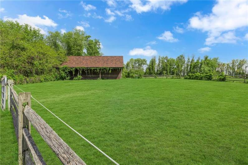 Barn/Stable and fenced riding arena.