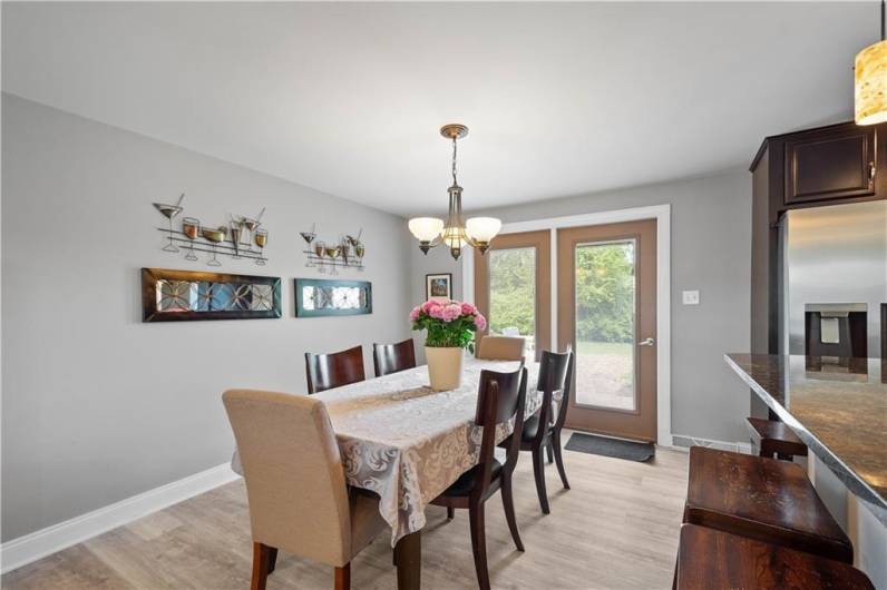 The Dining Area Features a Chandelier and Easy Access to the Rear Patio for Grilling Ease